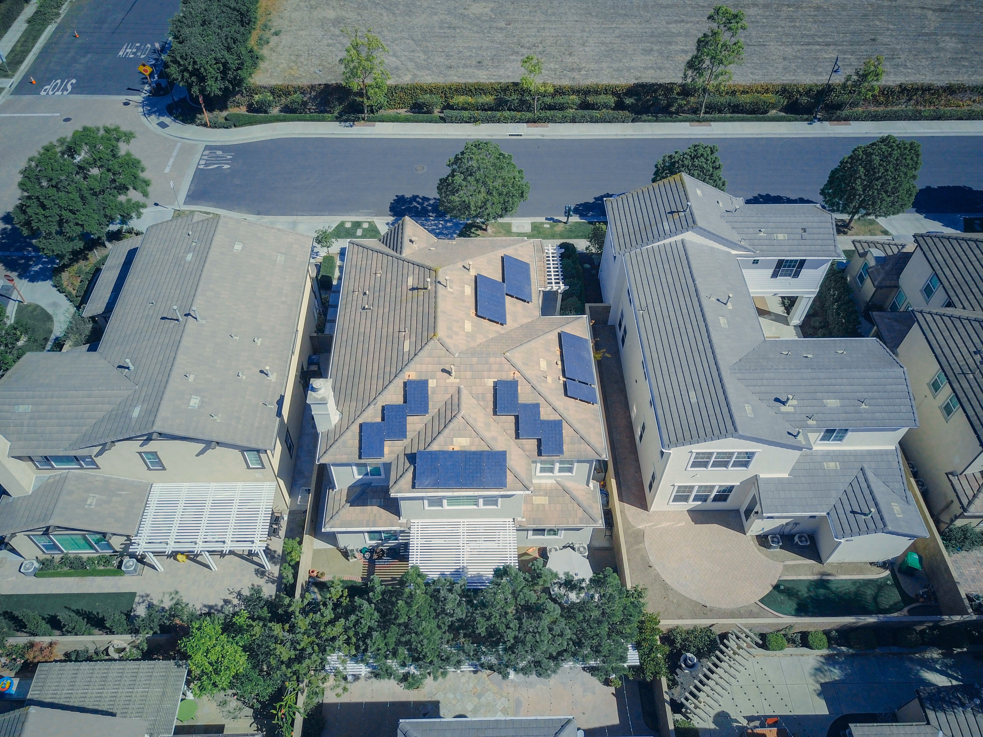 Aerial view of suburban homes with rooftop solar panels